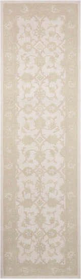 Close-up of Nourison Zephyr Ivory/Green rug. Handmade wool runner with chestnut floral pattern and border.
