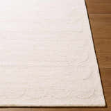 Close up of the hand tufted Kazuto Area Rug. Cream wool rug with subtle pattern detail. Front