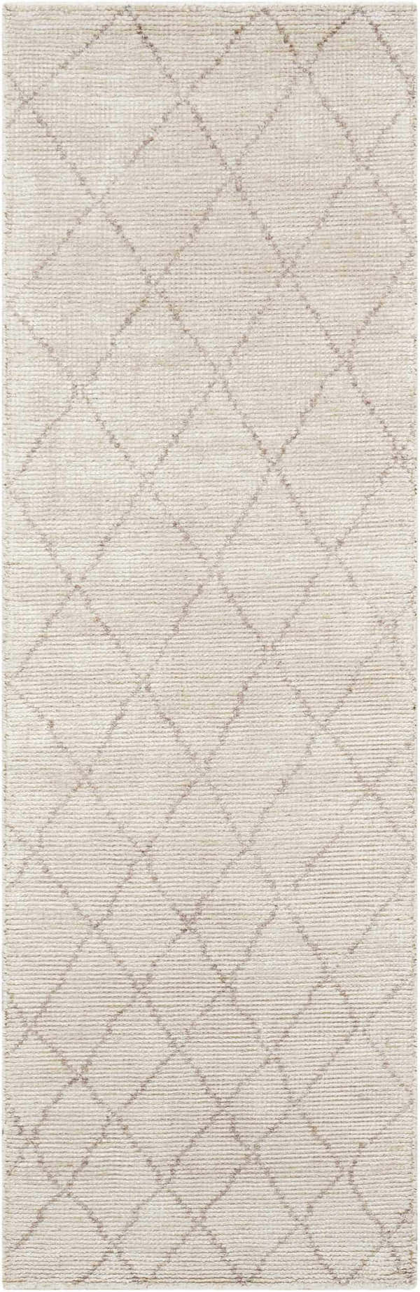 Close-up of the Calvin Klein Home Heath Tusk rug. Handmade rayon rug with a subtle diamond pattern in tusk color.
