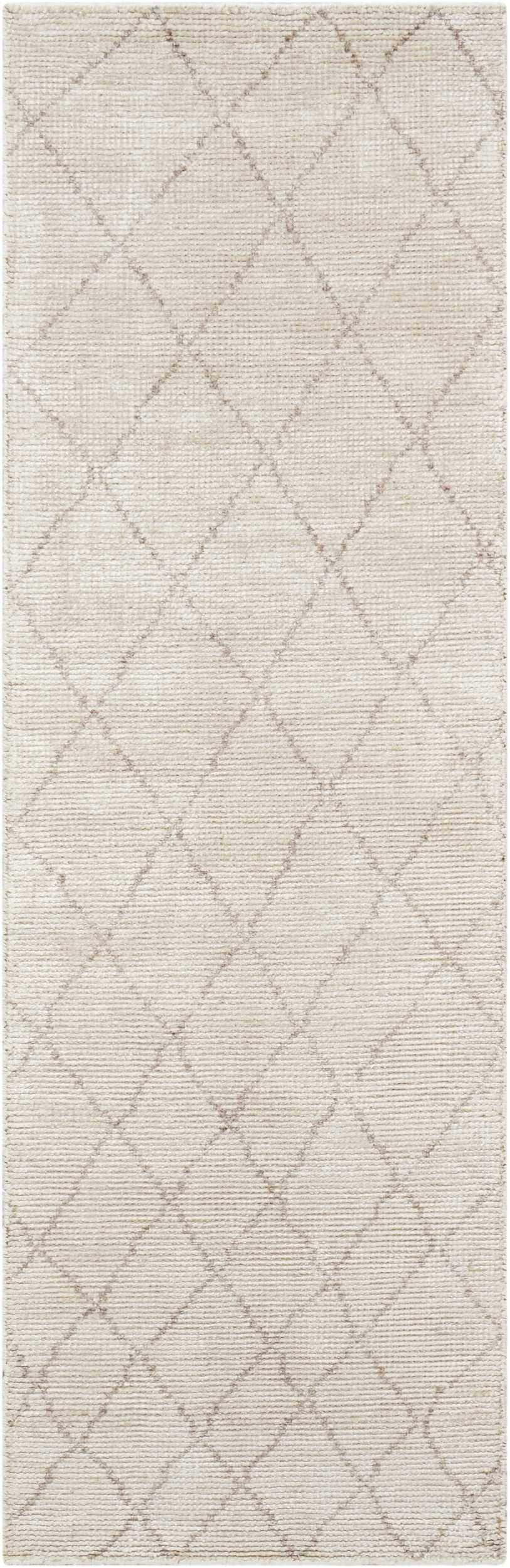 Close-up of the Calvin Klein Home Heath Tusk rug. Handmade rayon rug with a subtle diamond pattern in tusk color.