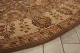 Close up of the Nourison 3000 Taupe Persian rug showing floral patterns and a border on a light wood floor.