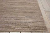 Close-up of the textured Calvin Klein Monsoon Loam rug. Handmade jute rug in neutral brown tones.