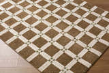 Close-up of the Kalkin Brown Area Rug. Features a geometric diamond pattern in dark brown, off-white, and olive green. Corner