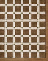 Close-up of the Kalkin Brown Area Rug featuring a brown, off-white, and olive green plaid pattern. Corner