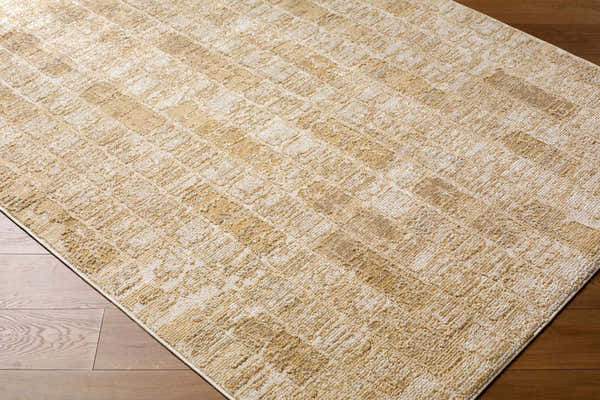 Close up of the Kapueo Area Rug, a light gray, off-white, and tan rug with a textured, geometric pattern. Corner