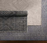Close-up of Lusacan Area Carpet in charcoal, gray, and off-white. Hand-knotted rug with a geometric pattern. Viscose texture. Styleshot