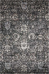 Close-up of the Nourison Twilight Onyx Persian rug. Black rug with distressed, intricate patterns in gray, beige, and brown tones.