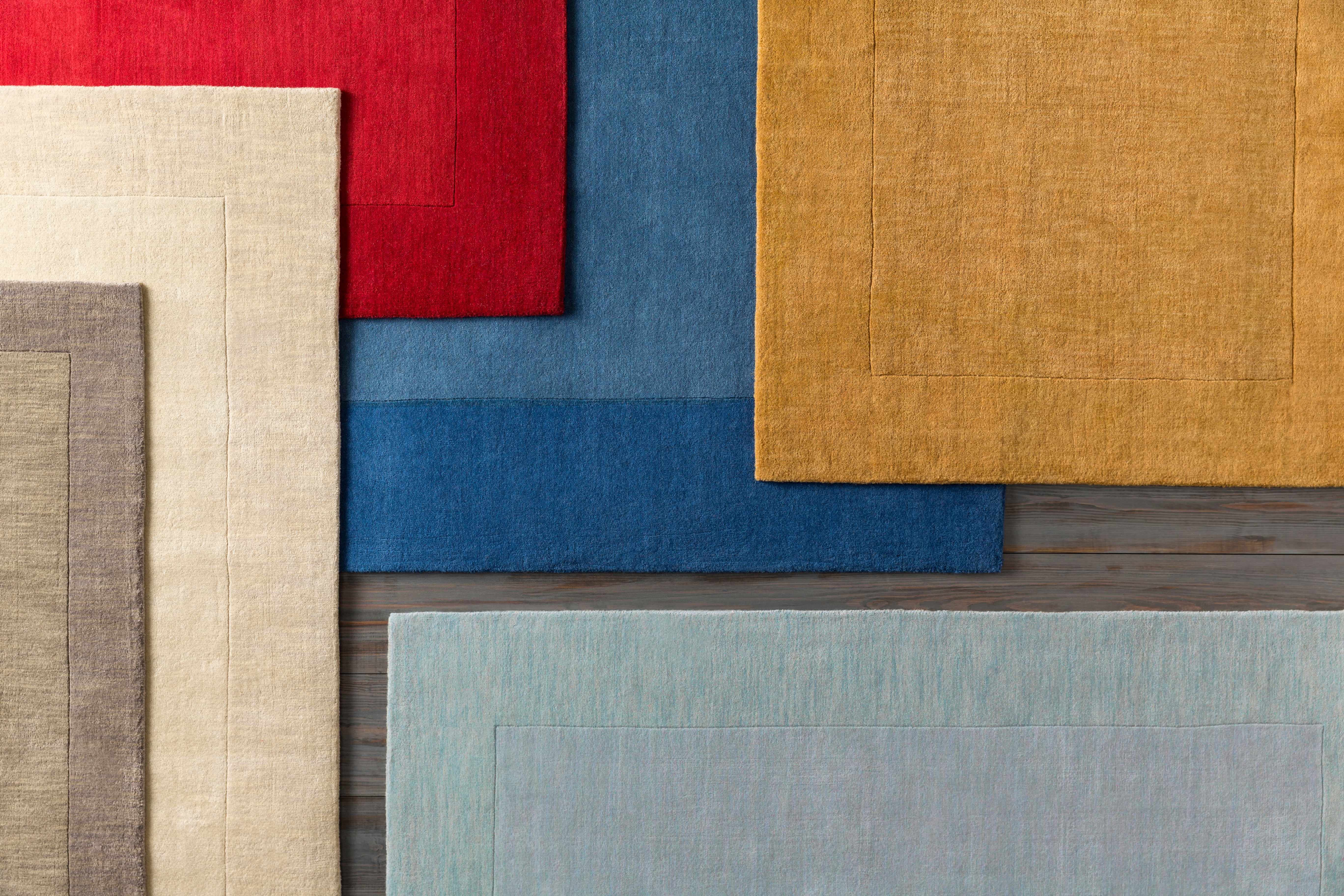 Reverse side of Bordered Solid Beige Cream Wool Rug, focusing on underside structure and material.Contemporary Area Rug Backing Canvas 