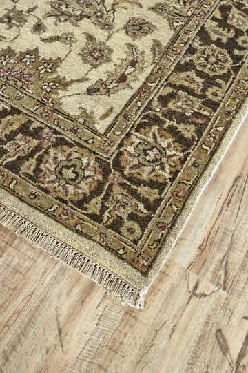 Close up of the Feizy Drake Ivory/Gold/Brown rug showing its traditional Persian floral pattern and wool texture. Corner