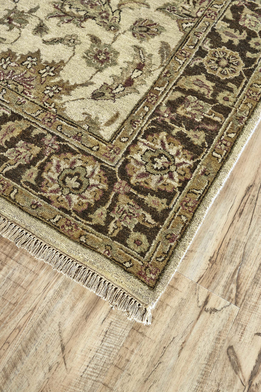 Close up of the Feizy Drake Ivory/Gold/Brown rug showing its traditional Persian floral pattern and wool texture. Corner