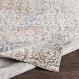 Close-up of the Marden Textured Luxe Area Rug showing its brick red, camel, and gray traditional pattern and textured weave. Fold