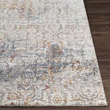 Close-up of the Marden Textured Luxe Area Rug showing brick red, camel, and gray floral pattern on dark wood floor. Front