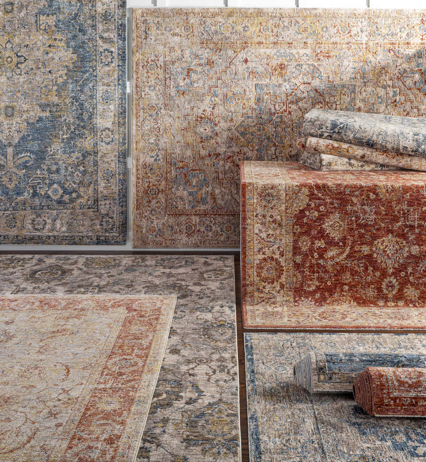 Variety of Morinville rugs in teal, brown, red, and gray with traditional floral patterns, displayed flat and rolled. Styleshot