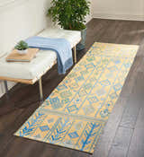 Entryway with white bench and Nourison Madera Saffron runner rug. Tribal design in mustard, blue, and green.