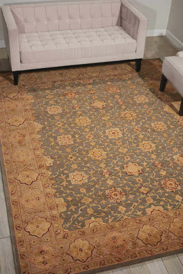 Living room scene with a blush sofa on a Nourison 3000 Aqua Persian rug with floral and vine design.