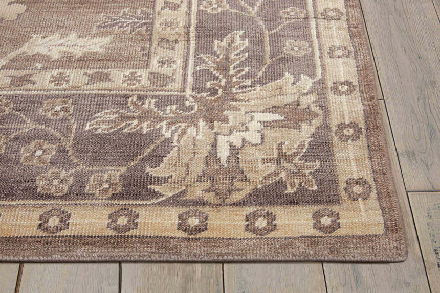 Close up of the Nourison Aldora Opal Grey vintage rug showing floral pattern and border detail.