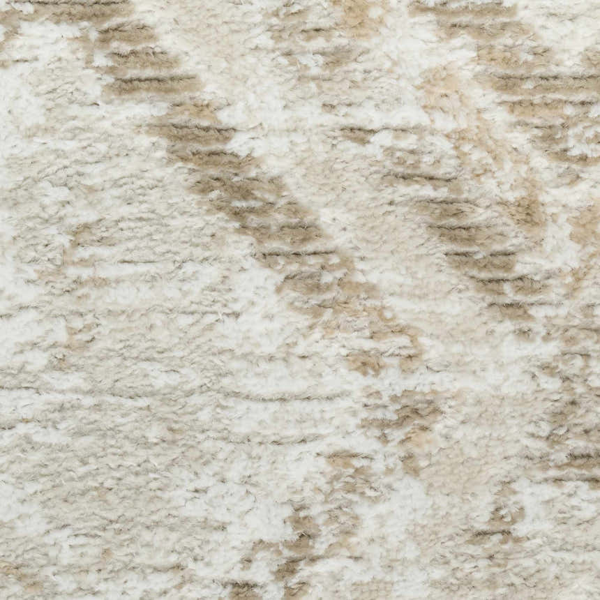 Close-up of the high pile Nourison Dekor Ivory Taupe rug. Machine-made with a modern ivory and taupe design.