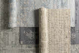 Close-up of embossed Galchutt rug samples in gray, charcoal, and light gray. Viscose and wool blend with textured patterns. Styleshot
