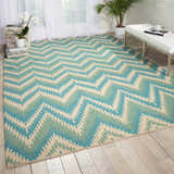 Living room scene with a Barclay Butera Prism Pacific rug in Pacific color, featuring a zigzag pattern.