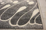 Close-up of the Nourison Maxell Grey rug showing its abstract, mid-century modern design and textured polyester material.