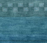 Close-up of the hand-tufted Rizzy MV3161 area rug. Features a farmhouse style blue wool with a subtle geometric pattern. Texture