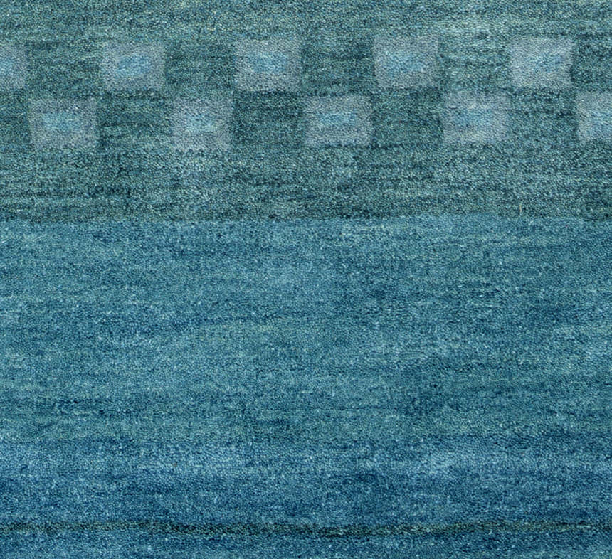 Close-up of the hand-tufted Rizzy MV3161 area rug. Features a farmhouse style blue wool with a subtle geometric pattern. Texture