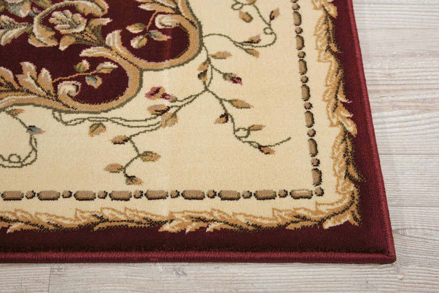 Close-up of the Nourison Bordeaux Burgundy Aubusson Rug. Features a floral design in burgundy and beige.