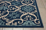 Close-up of Nourison Caribbean Navy Contemporary Area Rug showing a floral and scroll pattern in navy, cream, and light blue.