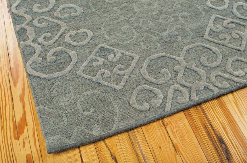 Close-up of the taupe Nourison Ambrose Slate rug showing wool texture and a raised, swirling geometric pattern.