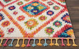 Close-up of the Nourison Nomad Ivory Pink Tribal rug showing colorful floral pattern and tassels.