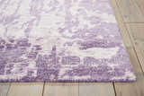 Close up of the Nourison Silk Shadows Amethyst rug showing its vintage purple pattern and soft texture.