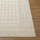 Close-up of the Shanti Nabela Noor Home x LIVABLISS NBSH-2300 Area Rug. Farmhouse style rug in off-white and taupe on wood floor. Front