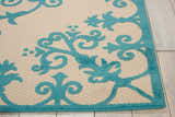 Close-up of the Nourison Aloha Aqua Outdoor Area Rug, featuring a floral aqua pattern on a cream background.