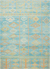 Close-up of Nourison Madera Sky Blue rug. Tribal design with orange, yellow, and white geometric patterns on a sky blue background.