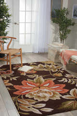 Light-filled room with Nourison Fantasy Chocolate rug featuring a large floral design in brown, peach, and green tones.