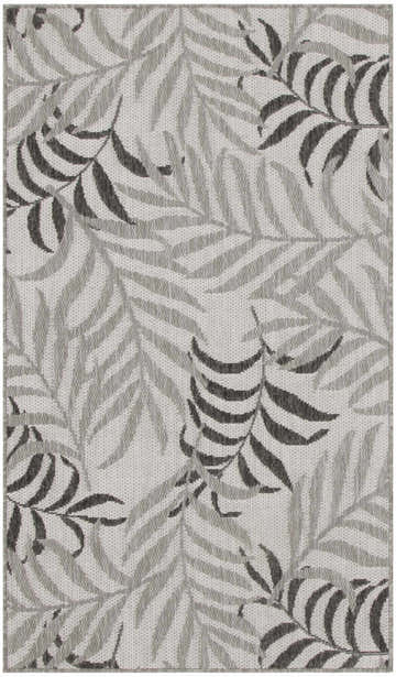Close-up of the Nourison Garden Oasis Grey Tropical Area Rug. Features a gray and white tropical leaf pattern.