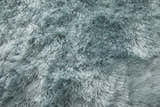 Close-up of the plush Feizy Indochine Modern Solid Area Rug in blue and silver gray, showing the soft, hand-tufted texture. Texture