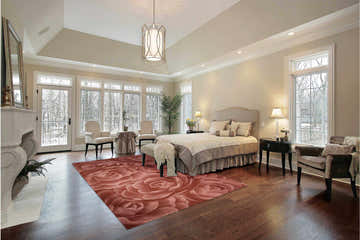 Bedroom scene with a blush pink Nourison Moda Floral rug, hardwood floors, and neutral furniture.