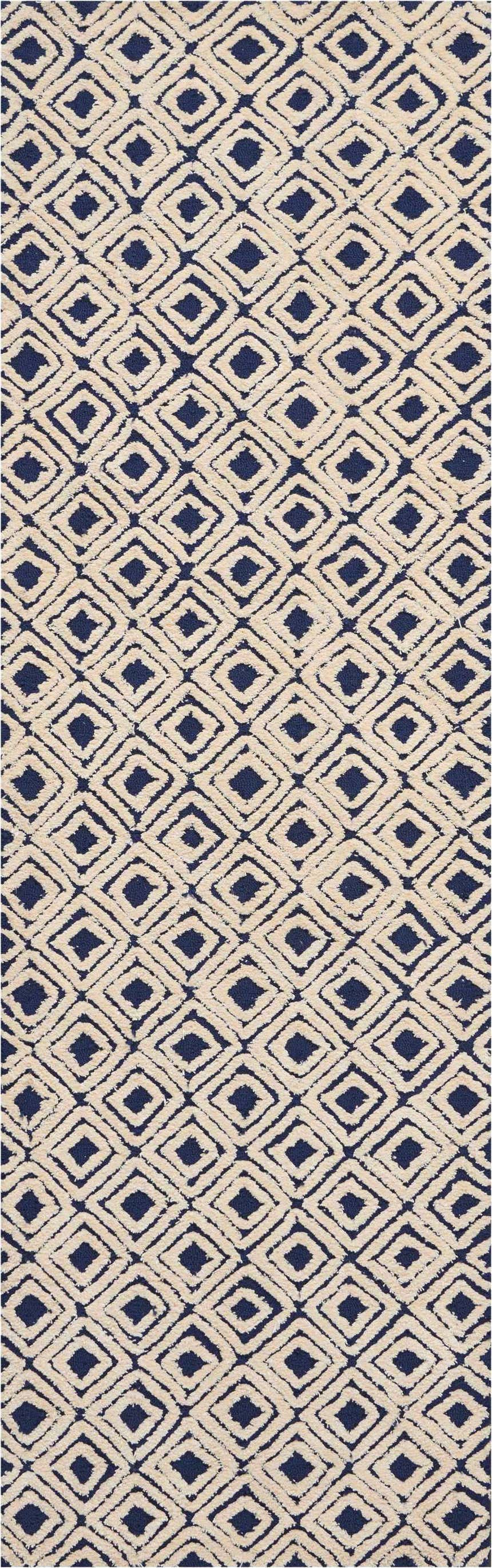Close-up of Nourison Deco Mod Navy Ivory rug. Diamond pattern, mid-century modern style, handmade texture.