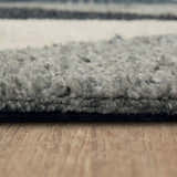 Close-up of the Karastan Oblique Blue Area Rug showing its charcoal, cream, and denim colors and plush texture. Pile