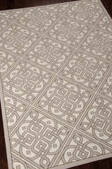 Close-up of Waverly Sun N' Shade Stone Modern Area Rug. Sandstone color, geometric pattern, and machine-made texture.