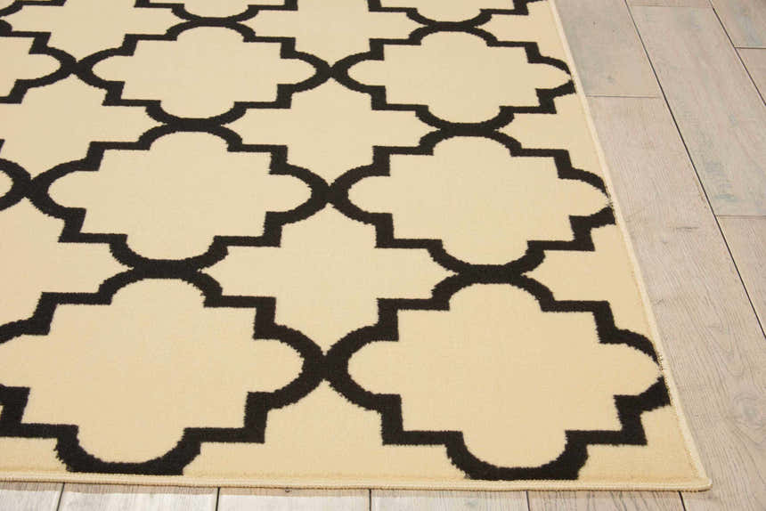 Close up of Nourison Grafix Cream Black Moroccan Rug showing geometric trellis pattern and soft texture.