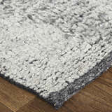 Close-up of the Feizy Alford rug; ivory, gray, and taupe wool with a geometric design and textured, hand-knotted pile. Corner