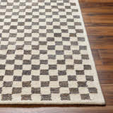 Close-up of the Halen Taupe Checkered Area Rug. Taupe and lambswool squares create a geometric, textured pattern. Front