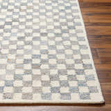 Close-up of the Halen Gray Checkered Area Rug showing the geometric checker pattern and wool texture on wood floors. Front