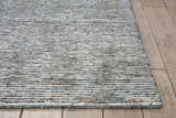 Close-up of the textured Nourison Ellora Slate Rug. Taupe, gray, and blue horizontal stripes on a handmade, mid-century modern rug.