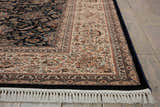 Close up of the Nourison Persian Palace Navy Persian Rug, showing its detailed floral pattern and fringe.