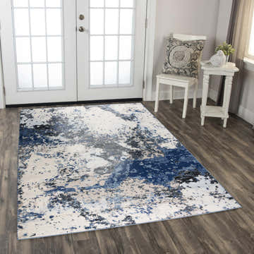 Entryway scene with Rizzy PLC855 abstract area rug in beige, black, blue and ivory. White french doors and chair. Roomscene-Rectangle