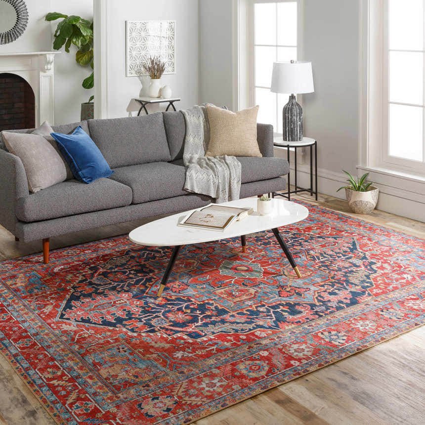 Living room scene with a gray sofa and the Pauline Red Medallion Performance Rug. The rug adds warmth and color to the neutral space. Roomscene-Rectangle