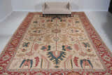 Living room scene with a light gold Nourison Nourmak vintage rug, beige sofa, and white walls.